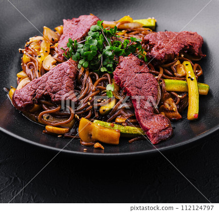 Chinese fried rice with beef on black plate Chinese fried rice with beef on black plate 112124797