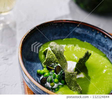 peas, broccoli, spinach cream soup in a bowl 112124844