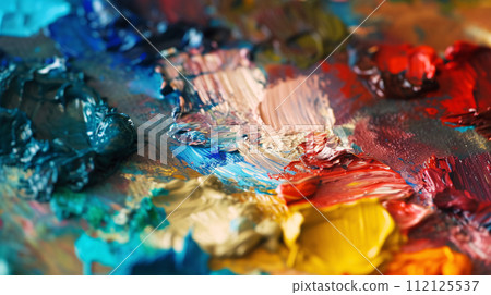 the tactile allure of an artist's palette, adorned with an array of vibrant paints 112125537