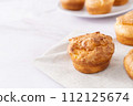 Popovers or Yorkshire pudding on linen napkin on a white background, tasty food, easy breakfast, copy space. 112125674