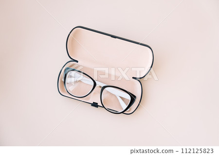 Eyeglasses with black frames in a light case Eyeglasses with black frames in a light case 112125823