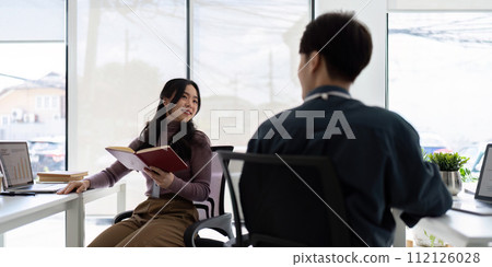 Business team working using laptop computer sitting at table. colleague company discussing data management using laptop compute at consulting Business team working using laptop computer sitting at table. colleague company discussing data management using laptop compute at consulting 112126028