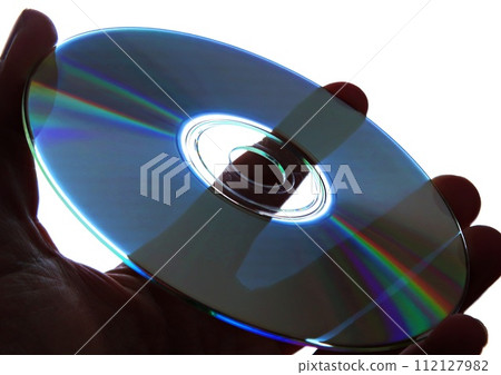 Holding a compact disc in hand 112127982