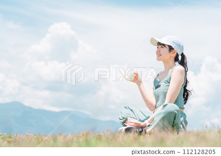 Young asian woman drinking protein while exercising under blue sky Young asian woman drinking protein while exercising under blue sky 112128205