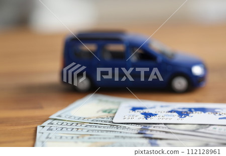 Close up dollars and credit card auto background Close up dollars and credit card auto background 112128961