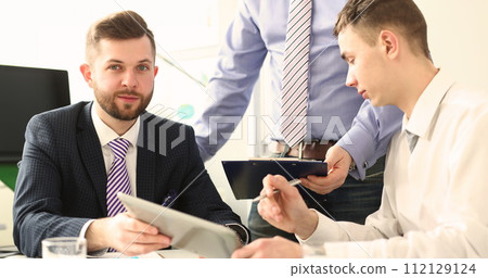 Handsome bearded businessman in suit and tie during meeting 112129124