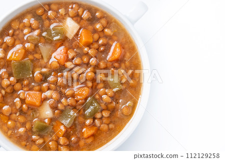 Lentil soup with vegetables in bowl isolated on white background 112129258