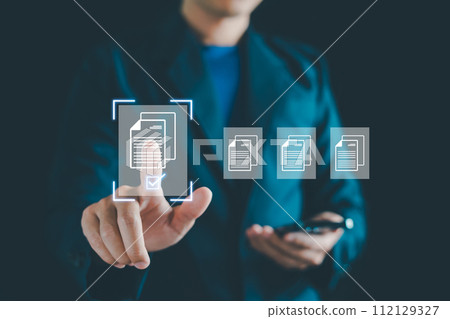 E-document management, Businessman touching on document for online approve paperless quality assurance and ERP management concept. Online documentation database, paperless office concept. 112129327