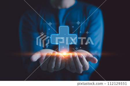 Healthcare insurance and medicine concept. Businessman holding virtual blue plus sign for positive thinking mindset or healthcare insurance symbol, Mental health care, mental rejuvenation. Healthcare insurance and medicine concept. Businessman holding virtual blue plus sign for positive thinking mindset or healthcare insurance symbol, Mental health care, mental rejuvenation. 112129331