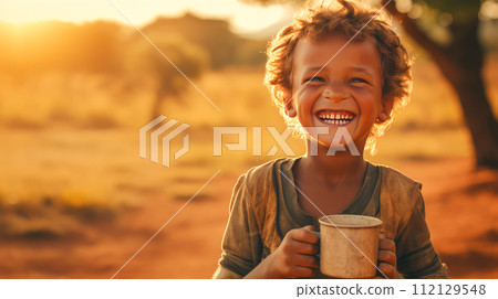Poor, beggar, hungry Caucasian child boy in Africa, thirsty to drink water. 112129548