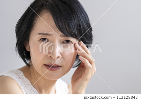Beauty image portrait of a woman in her early 50s with an anxious and worried expression 112129848