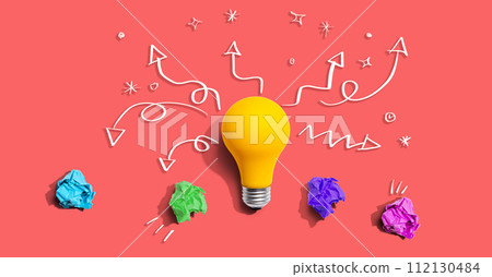 Brainstorming concept with a idea light bulb and crumpled paper 112130484