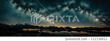 Marvel of a starry night sky in a remote location, with a silhouette of a distant mountain 112130612