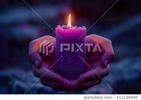 Close-up of a person's hands gently holding a lit purple candle. Generative AI. 112130940