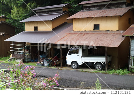 Old barn and light truck in the countryside 112131121