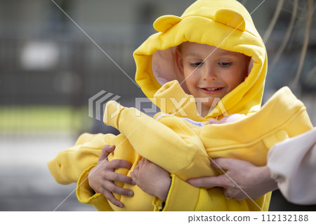 Happy little boy holding newborn brother or sister in his arms. Meeting with the maternity hospital. Happy little boy holding newborn brother or sister in his arms. Meeting with the maternity hospital. 112132188