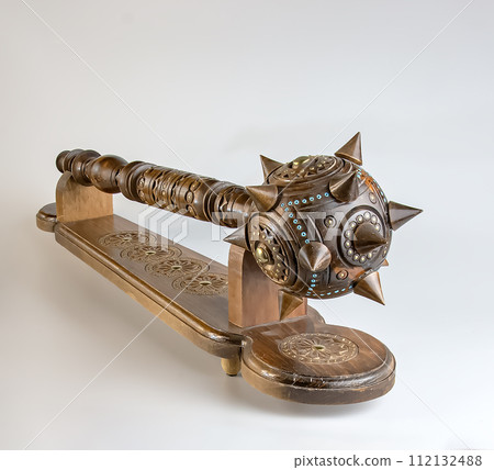 Souvenir wooden Hetman's Mace on a stand on a white background. Ukraine. 112132488