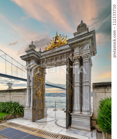 Marble gate with decorated door leading to sea, with Bosphorus Bridge in the background, Beylerbeyi Palace, Istanbul 112133710