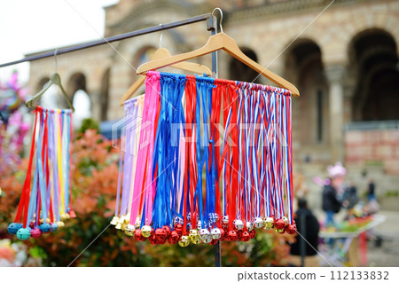 Vrbica orthodox holiday. Small bells, wreaths from willow branches and flowers selling near church. Kids and young girls wearing wreaths. 112133832