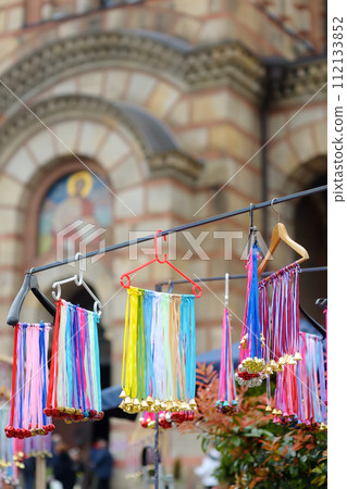 Vrbica orthodox holiday. Small bells, wreaths from willow branches and flowers selling near church. Kids and young girls wearing wreaths. 112133852