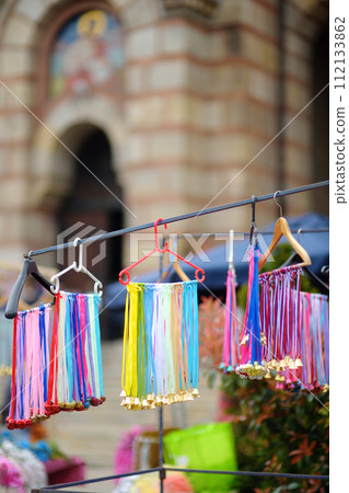 Vrbica orthodox holiday. Small bells, wreaths from willow branches and flowers selling near church. Kids and young girls wearing wreaths. 112133862