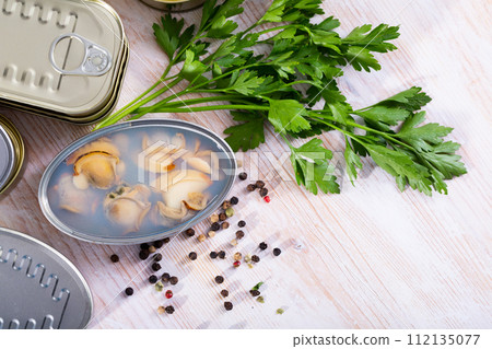 Open tin can with sea clams in its own juice 112135077