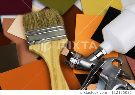 Paint spray gun at work at the workplace in the workshop. Paint Brush 112135083