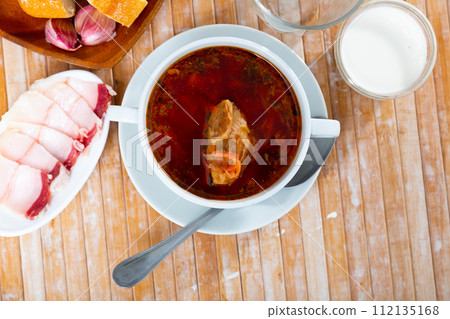 Borscht in bowl with sliced salo Borscht in bowl with sliced salo 112135168