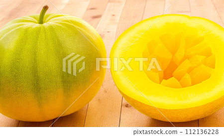 Melon close up on wooden table. Melons whole and piece 112136228