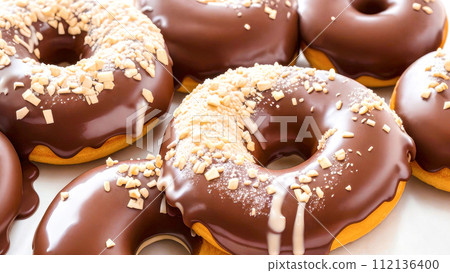 Chocolate Donuts dusted with peanut crumbs. Set of chocolate doughnuts Close-up 112136400