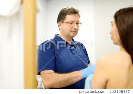 Doctor mammologist examines woman breasts. Correcting the shape of the breast - lift, reduction, reconstruction, augmentation. Problems of lactation. Breast cancer. 112136577