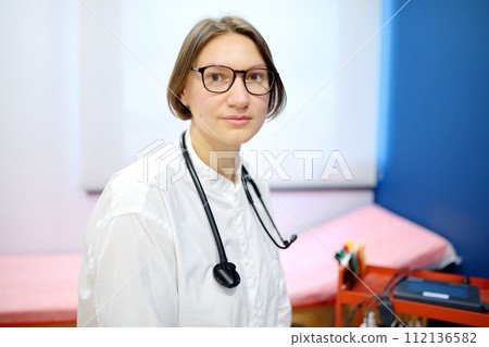 Portrait of female doctor cardiologist during appointment of patient. Cardiology consultation and treatment of heart diseases 112136582