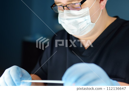Portrait of a professional vascular surgeon in the operating room of the clinic during vein surgery 112136647
