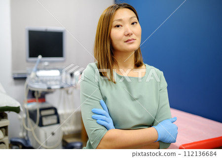 Portrait of asian female obstetrician gynecologist in office during work. Professional and responsible doctor working in a modern clinic of city 112136684