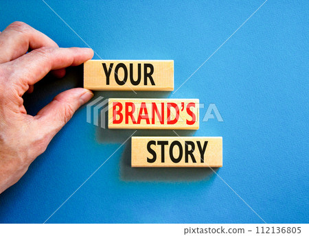 Branding and your brand story symbol. Concept words Your brands story on beautiful wooden blocks. Beautiful blue background. Businessman hand. Business branding your brand story concept. Copy space. Branding and your brand story symbol. Concept words Your brands story on beautiful wooden blocks. Beautiful blue background. Businessman hand. Business branding your brand story concept. Copy space. 112136805