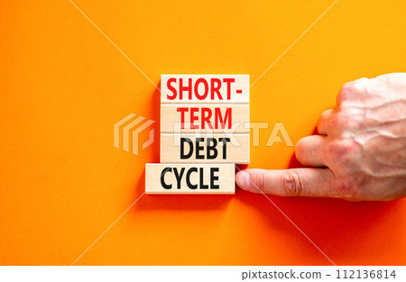 Short-term debt cycle symbol. Concept words Short-term debt cycle on beautiful wooden block. Beautiful orange table background. Businessman hand. Business Short-term debt cycle concept. Copy space. 112136814