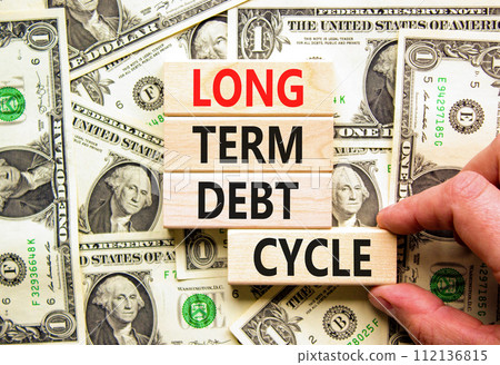 Long term debt cycle symbol. Concept words Long term debt cycle on beautiful wooden block. Beautiful dollar bills background. Dollar bills. Business Long term debt cycle concept Copy space 112136815