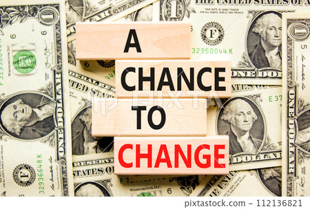 A chance for change symbol. Concept words A chance for change on beautiful wooden block. Beautiful dollar bills background. Dollar bills. Business A chance for change concept. Copy space. A chance for change symbol. Concept words A chance for change on beautiful wooden block. Beautiful dollar bills background. Dollar bills. Business A chance for change concept. Copy space. 112136821