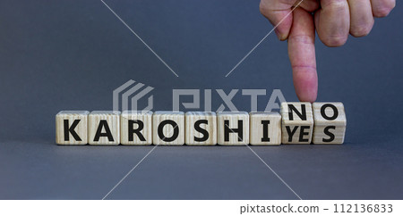 Karoshi yes or no symbol. Concept words Karoshi Yes or No on beautiful wooden blocks. Beautiful grey table grey background. Businessman hand. Business and stop karoshi concept. Copy space. Karoshi yes or no symbol. Concept words Karoshi Yes or No on beautiful wooden blocks. Beautiful grey table grey background. Businessman hand. Business and stop karoshi concept. Copy space. 112136833