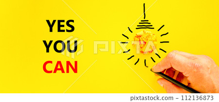 Motivational Yes you can symbol. Concept words Yes you can on beautiful yellow paper. Beautiful yellow background. Light bulb. Businessman hand. Business motivational Yes you can concept. Copy space 112136873