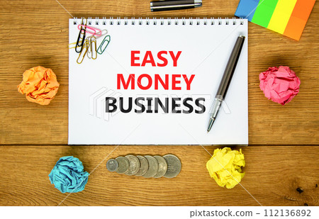 Easy money business symbol. Concept words Easy money business on beautiful white note. Beautiful wooden background. Black pen. Colored paper. Easy money business concept. Copy space. 112136892