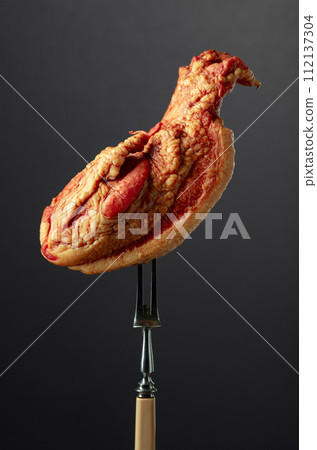 Smoked pork on a fork. 112137304