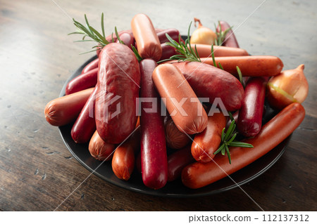 Various sausages with rosemary and onion. 112137312