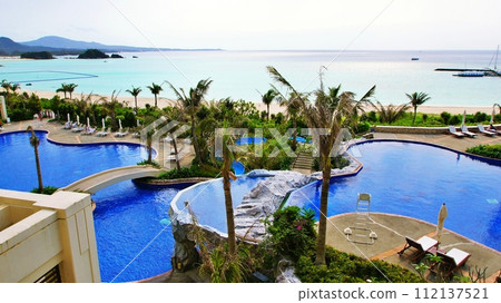 Pool scenery of a tropical resort hotel 112137521