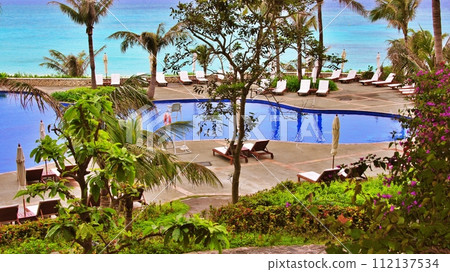 Poolside scenery at a tropical resort hotel 112137534