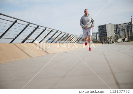 Exercise, workout, fitness, active healthy lifestyle and sport training concept with a healthy man running in the city. 112137792