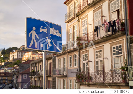Home zone road sign in Porto, Protugal on old houses background 112138022