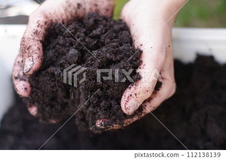 A person is holding a handful of dirt A person is holding a handful of dirt 112138139