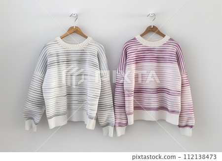 AI-generated content. Elegant striped sweaters hanging on the wall are a modern fashion statement for your fall/winter wardrobe. 112138473