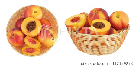 Ripe nectarine fruit with half in a wicker basket isolated on white background with full depth of field. Top view. Flat lay Ripe nectarine fruit with half in a wicker basket isolated on white background with full depth of field. Top view. Flat lay 112139258